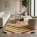 Chevron stripe Azilal Berber rug in a cozy living room with neutral sofa and wood table