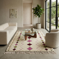 Plum and olive diamond Azilal Berber rug in a calm living room with boucle sofa