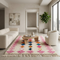 Pink diamond Azilal Berber rug in a bright living room with boucle sofa and round chair