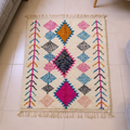 Azilal ivory wool rug with nested cyan, magenta and orange Amazigh diamonds, shown flat