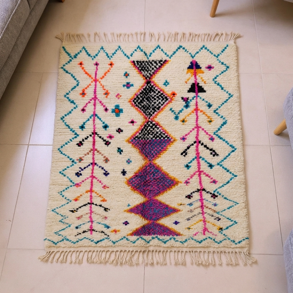 Azilal ivory wool rug with purple-orange diamonds and turquoise tree branches, shown flat
