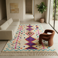 Ivory Azilal rug with purple diamonds and turquoise motifs in a sunlit modern living room