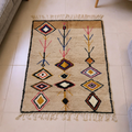 Azilal wheat wool rug with mustard, red and purple Amazigh diamonds and tree motifs, shown flat