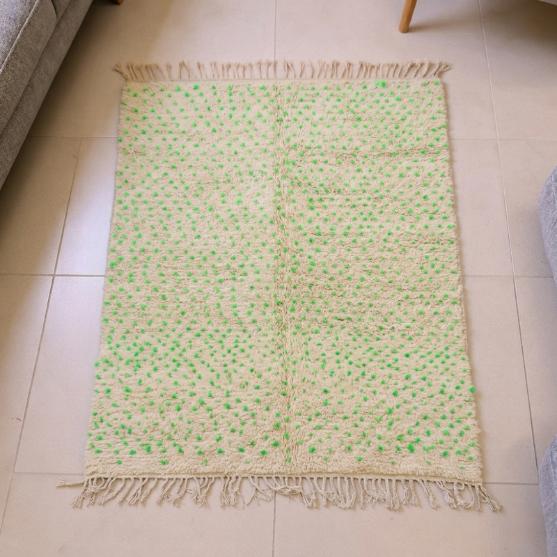 Beni Ourain ivory wool rug with all-over green and pink speckles, shown flat