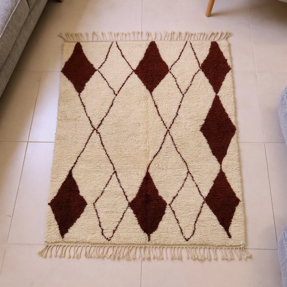 Beni Ourain ivory wool rug with a diamond trellis and burgundy filled lozenges, shown flat