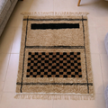 Beni Ourain ivory and black checkerboard wool rug, shown flat