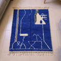 Beni Ourain cobalt blue abstract wool rug with ivory motifs, shown flat