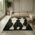 High-contrast black Beni Ourain rug with organic ivory shapes in a contemporary room