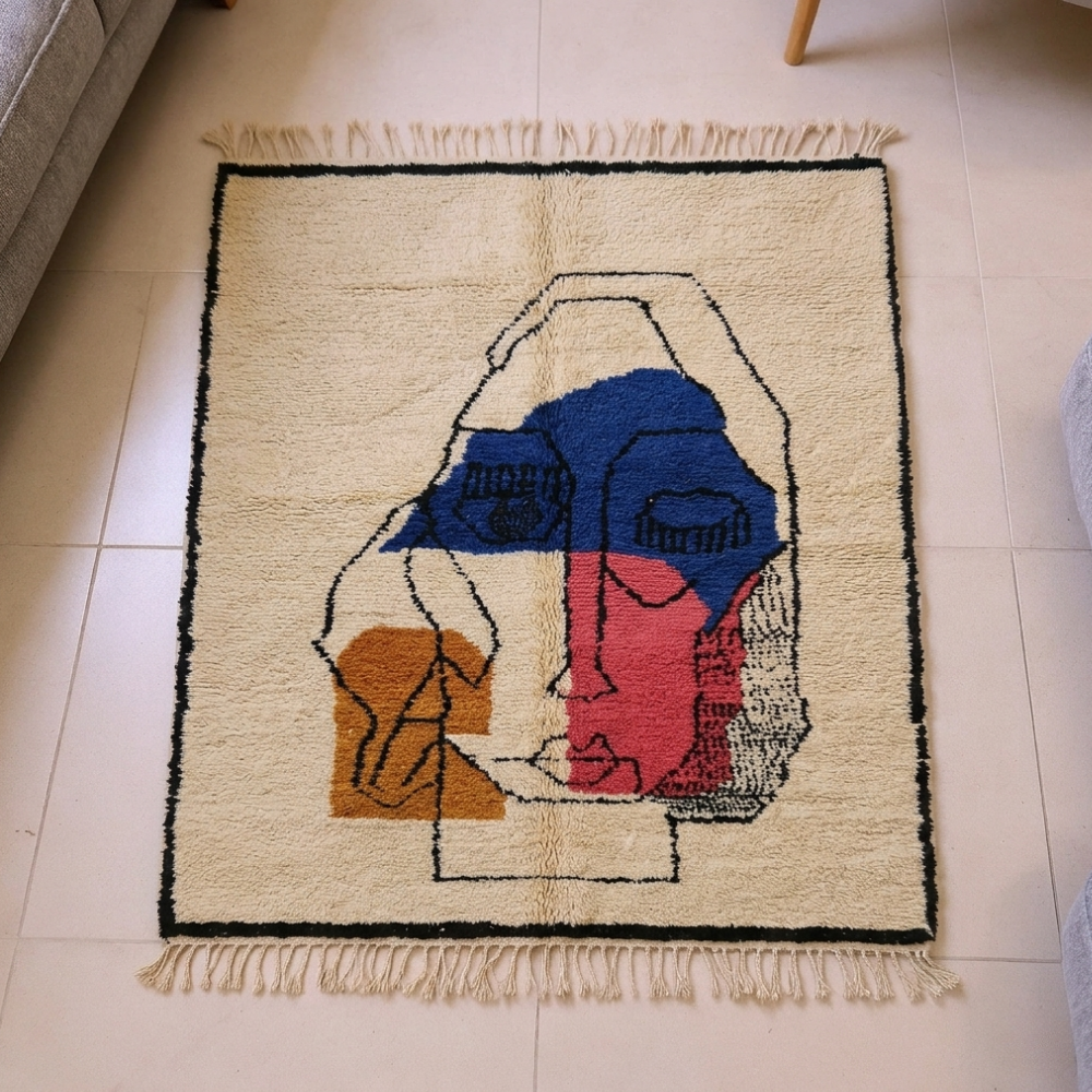 Beni Ourain ivory abstract face wool rug with blue, pink and orange, shown flat