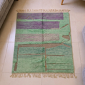 Mrirt sage green and lavender color block flatweave rug with rust lines, shown flat