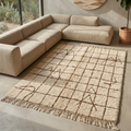 Moroccan Mrirt grid rug with tribal symbols under a coffee table in a sunlit room