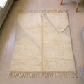 Mrirt solid ivory plush wool rug with a single subtle abstract line and fringe tassels, shown flat