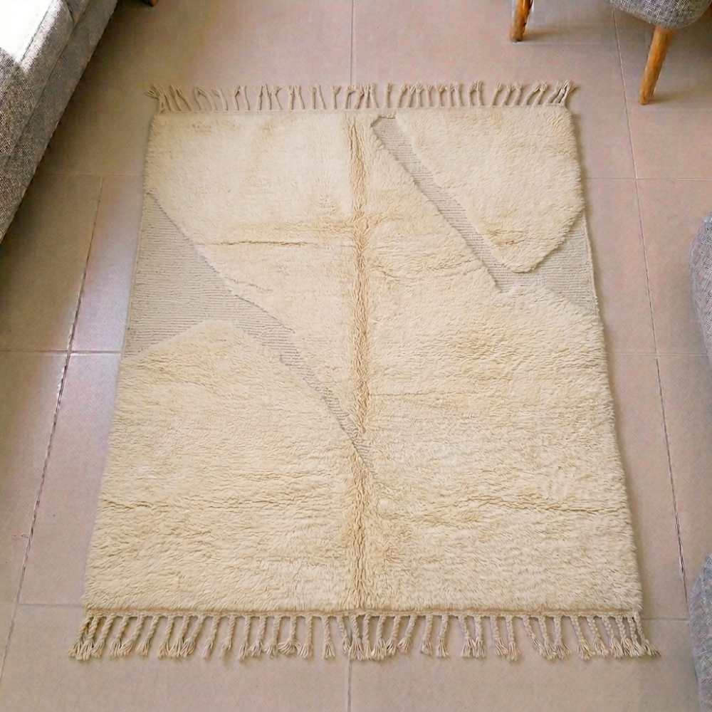 Mrirt solid ivory plush wool rug with a single subtle abstract line and fringe tassels, shown flat