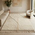 Plush ivory Moroccan Mrirt rug under a round coffee table in a sunlit room