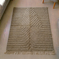 Mrirt taupe and grey-brown wool rug with carved radiating chevron ridges, shown flat