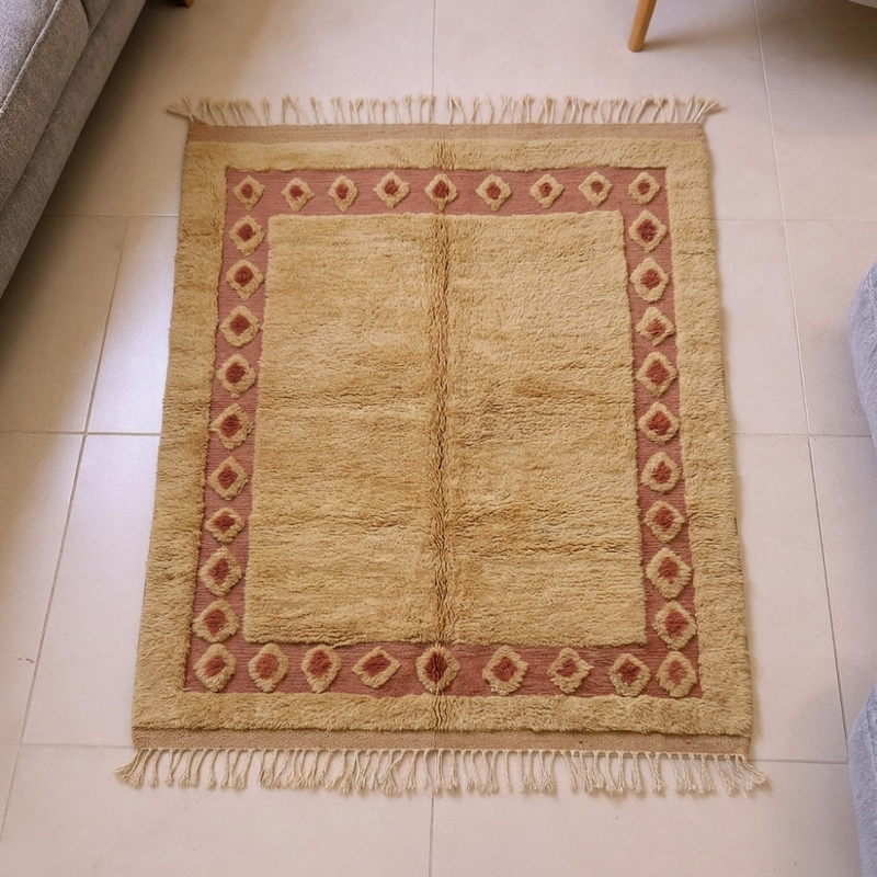 Mrirt golden-camel wool rug with terracotta diamond border, shown flat