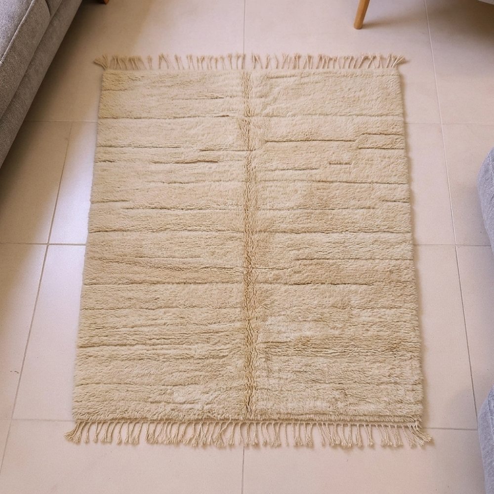 Mrirt ivory plush wool rug with carved grid and central column motif, shown flat