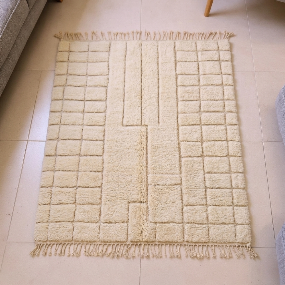Mrirt ivory plush wool rug with carved grid and central keyhole motif, shown flat