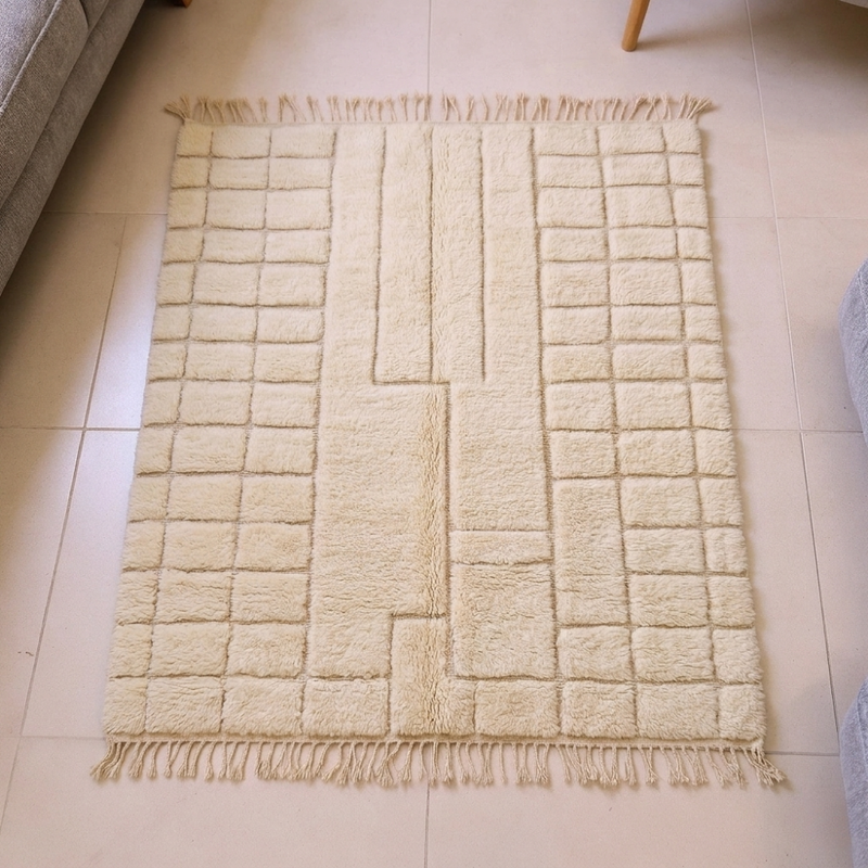 Mrirt ivory plush wool rug with carved grid and central keyhole motif, shown flat